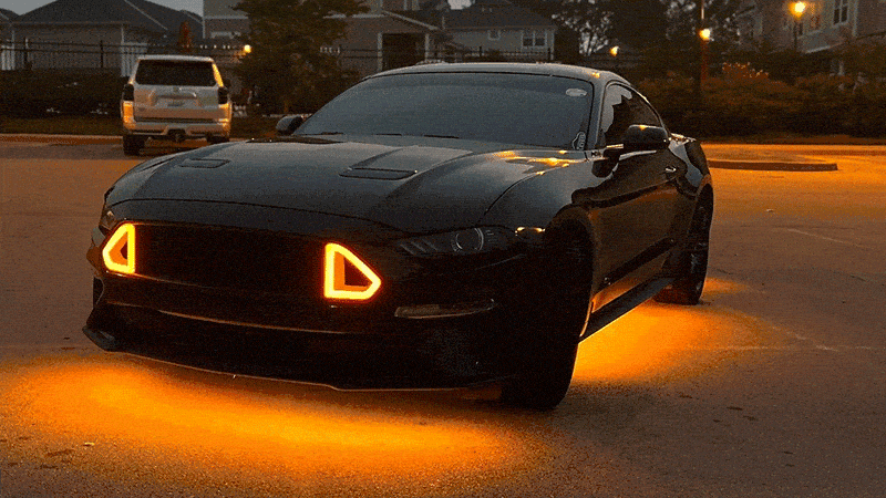 Black car with orange underglow parked